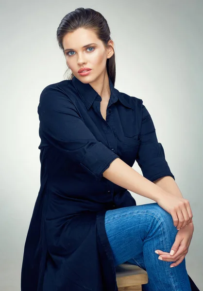 Young female fashion model seating on chair in studio black dres — Stock Photo, Image