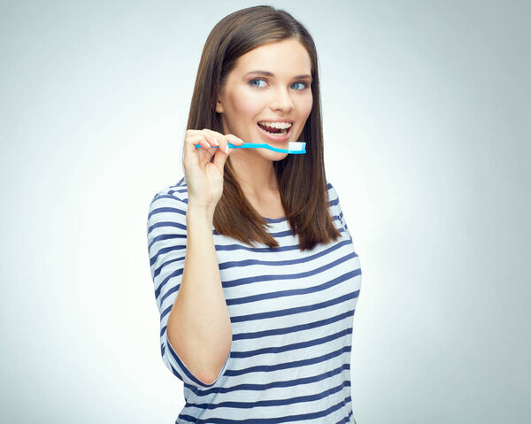 woman with braces holding toothbrush