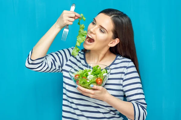 Young woman eating salad with hand — Stock Photo, Image