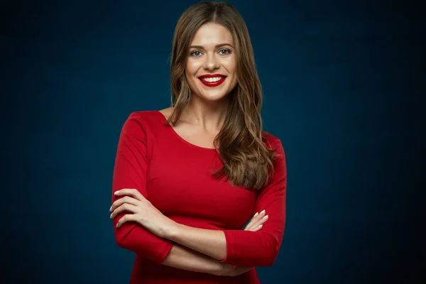 Toothy smiling woman wearing red dress with crossed arms — Stock Photo, Image