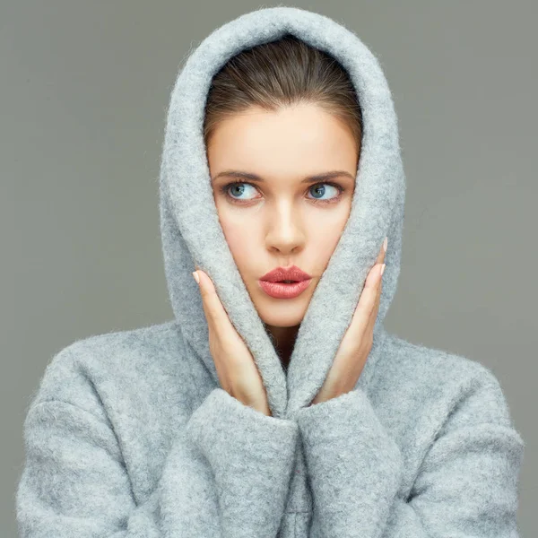 Young woman wearing coat hood sirprising. — Stock Photo, Image