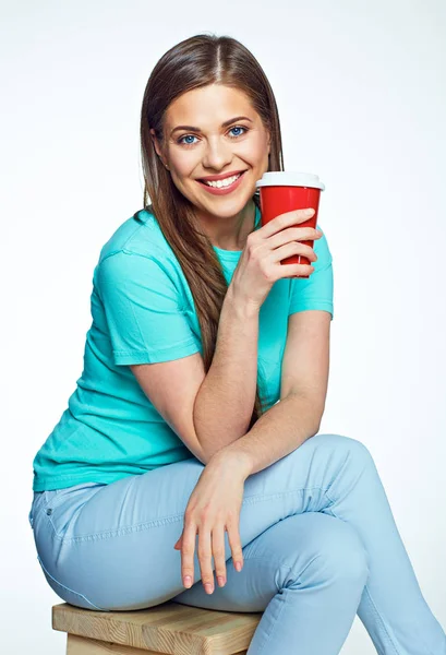 Woman sitting on chair with coffee cup — Stock Photo, Image
