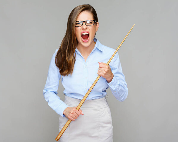 wicked woman teacher screaming while holding wooden pointer on grey background, education concept 