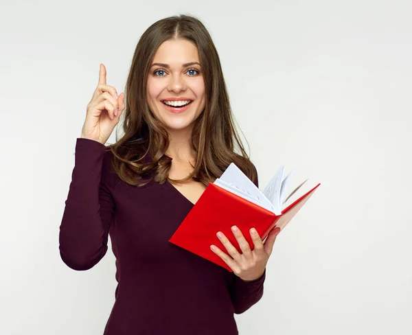 Estudiante chica sosteniendo rojo libro y señalando el dedo hacia arriba . — Foto de Stock