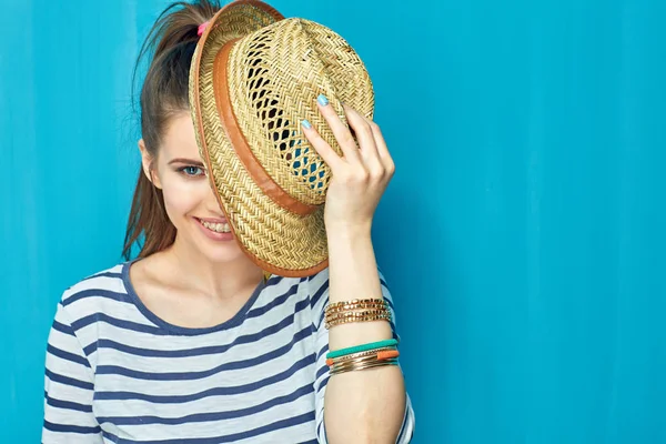 Smiling Woman Striped Shirt Holding Hat While Standing Blue Wall — Stock Photo, Image