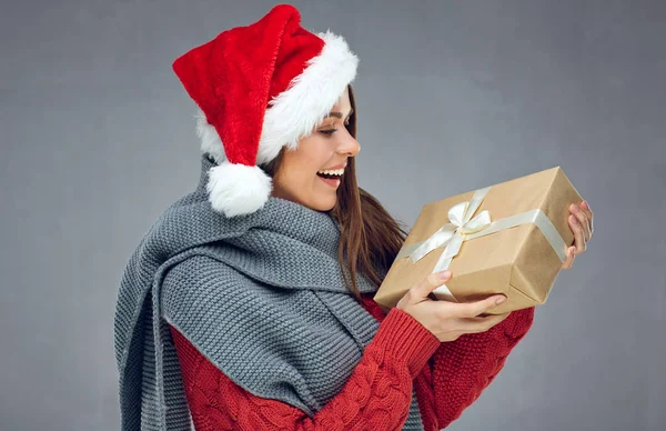 Happy woman wearing knitted sweater looking at Christmas gift. — Stock Photo, Image