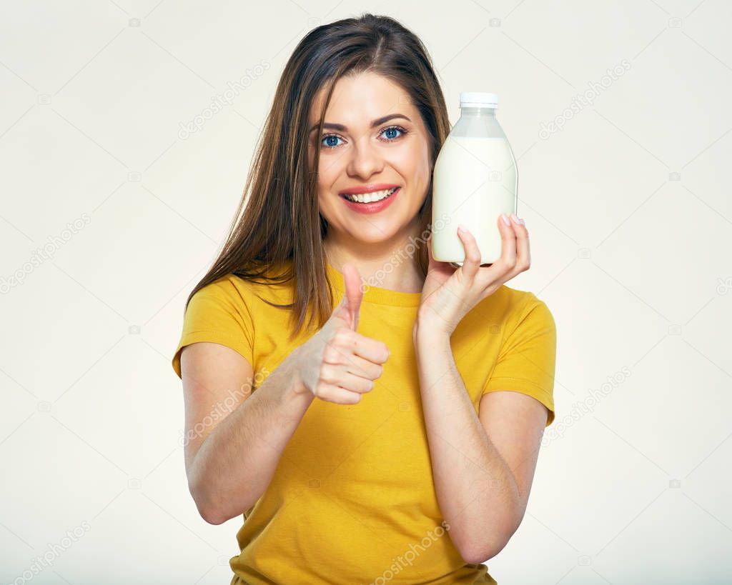Smiling woman holding milk bottle 