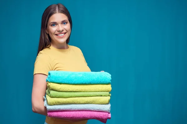 Smiling Woman Holding Pile Colorful Towels Blue Studio Background — Stock Photo, Image