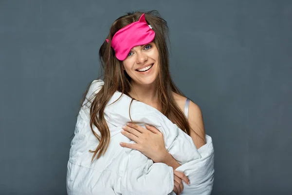 portrait of smiling woman with blanket and sleep mask, wake up concept
