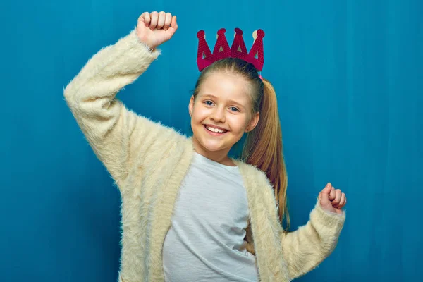Smiling girl with raising hand up. Portrait on blue — Stock Photo, Image