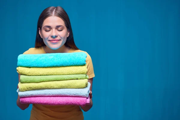 Smiling Woman Closed Eyes Holding Pile Colorful Towels Blue Studio — Stock Photo, Image