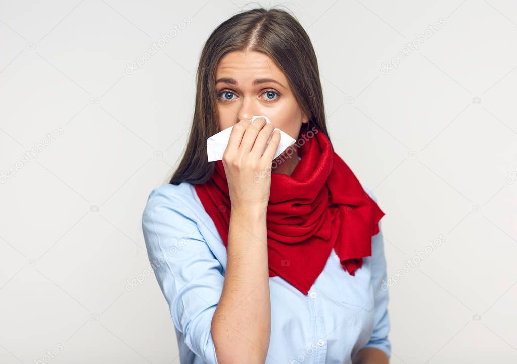 sick flu woman with red scarf on neck using paper tissue 