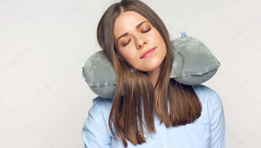 woman with closed eyes resting with travel pillow 