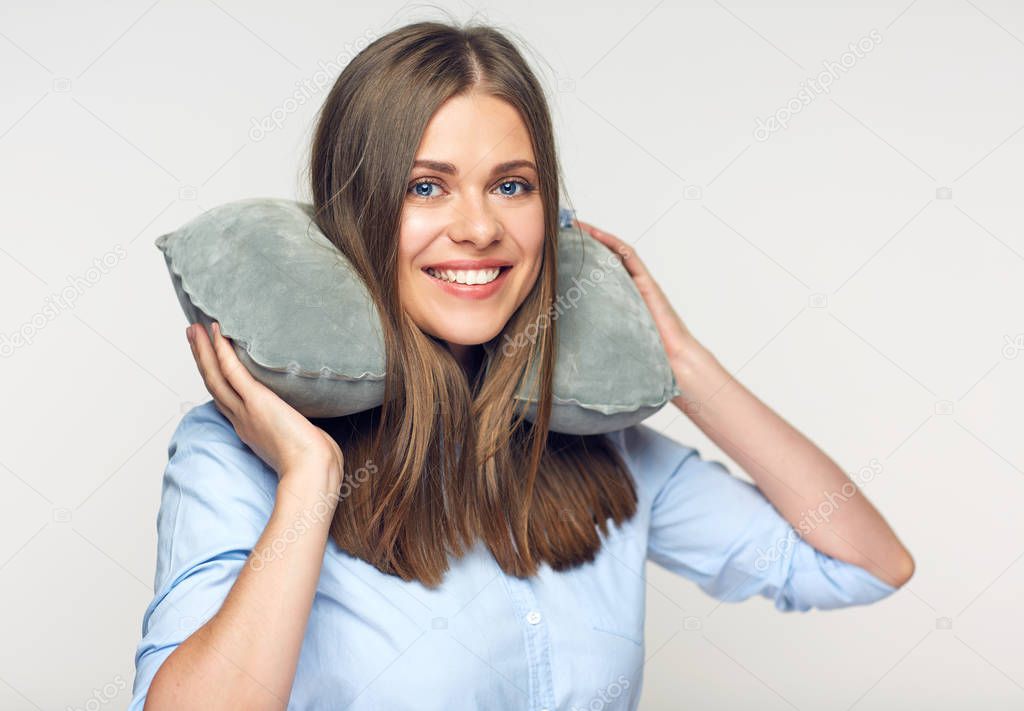 smiling beautiful woman resting with travel pillow 
