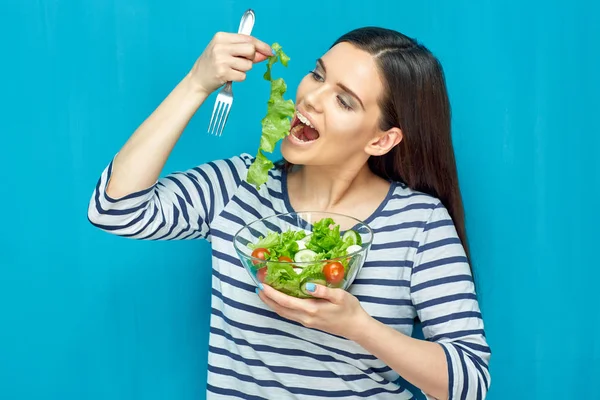 Happy young woman eating salad with hand. — Stock Photo, Image