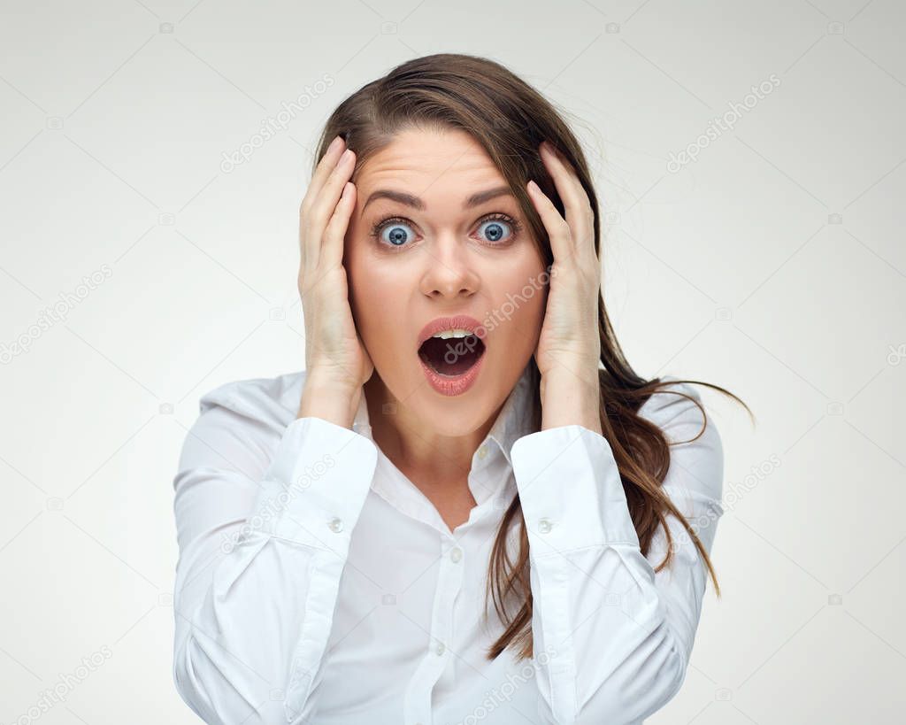shocked businesswoman in white shirt with opened mouth and big eyes looking at camera , concept of stress  