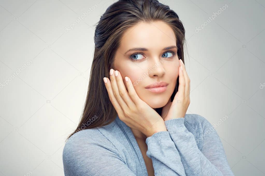 portrait of young beautiful woman touching cheeks by hands 