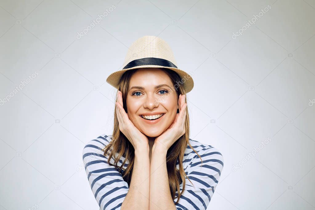 portrait of smiling woman in hat touching face isolated on white background, close-up 
