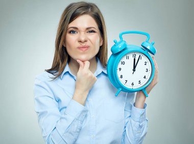 emotional portrait of businesswoman dressed in office shirt holding alarm clock, concept of panic on deadline time in business  clipart