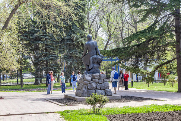 FEODOSIA, UKRAINE - May 07.2009: A group of tourists near the monument to the Russian poet A.S. Pushkin in the city square of the same name