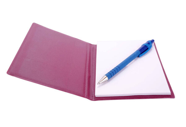 Ballpoint pen and open notebook isolated on white background