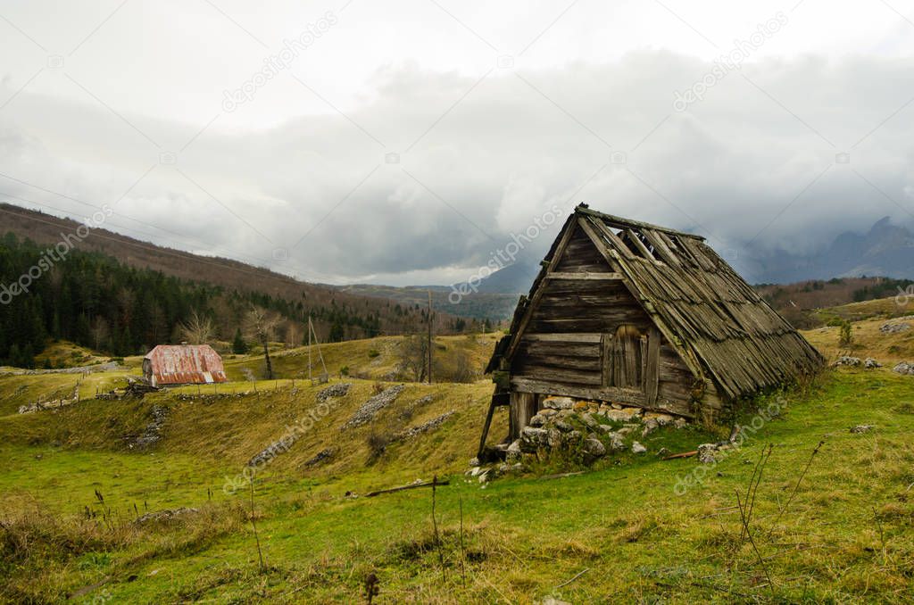 Authentic wooden shepherds cottage with pastoral landscape