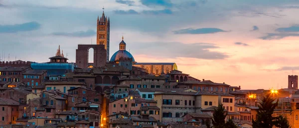 Siena against sunset sky clouds.Tuscany.Italy. Stock Picture