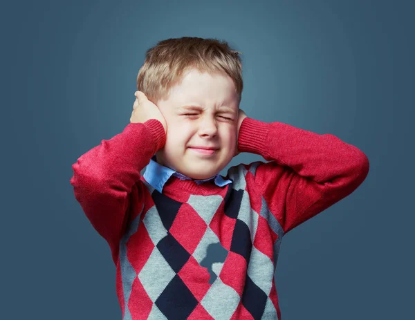 Scared boy closing ears — Stock Photo, Image
