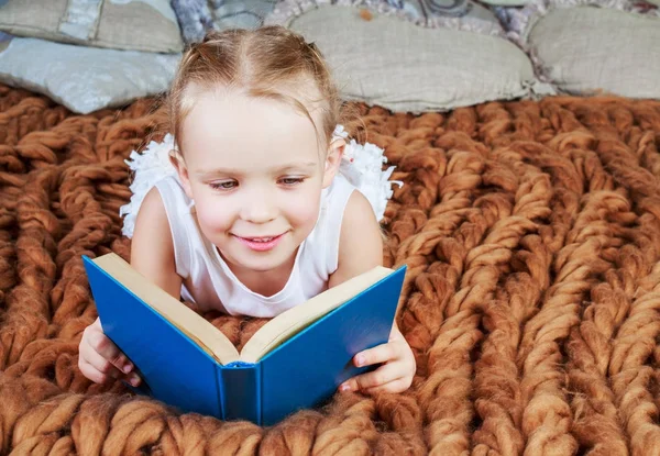 Dívka čte v posteli — Stock fotografie