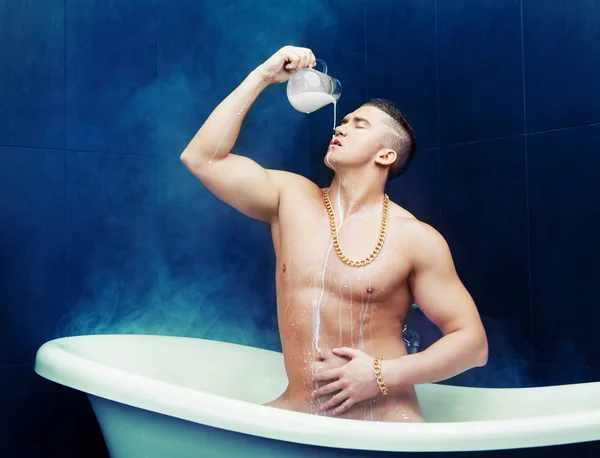 Homem tomando um banho com leite — Fotografia de Stock