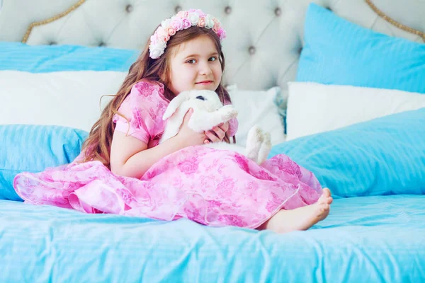 Happy little girl with a  rabbit — Stock Photo, Image