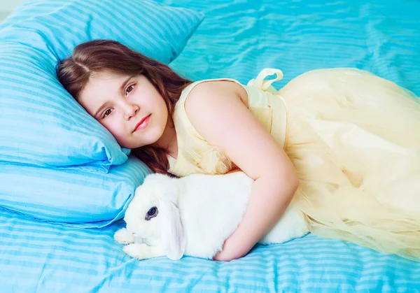 Счастливая маленькая девочка с кроликом — стоковое фото