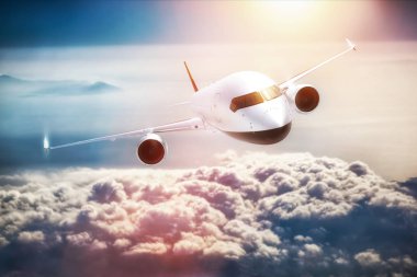 Passenger airplane flying at sunset  clipart