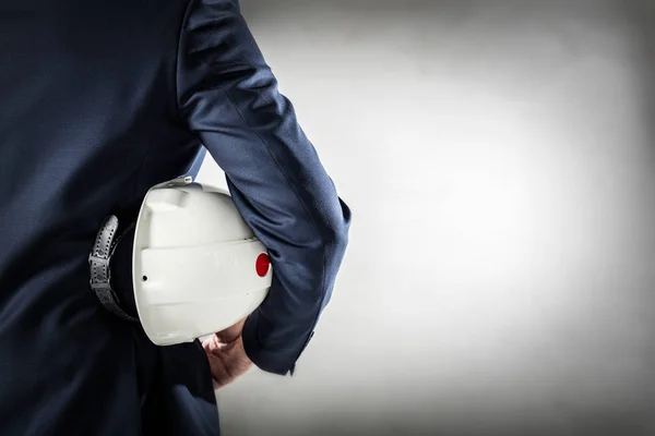 Businessman holding white safety helmet — Stock Photo, Image