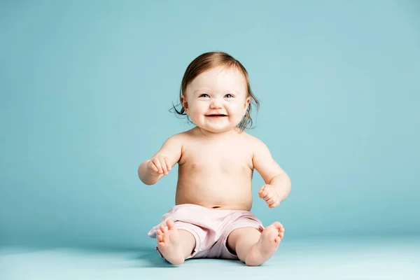 Smiling Little Girl Sitting Floor Light Blue Background — Stock Photo, Image