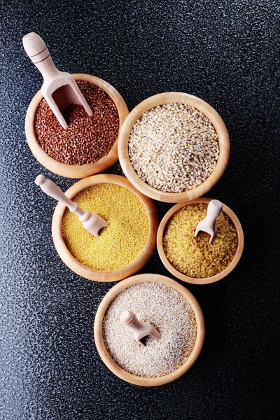 Various groats in bowls — Stock Photo, Image