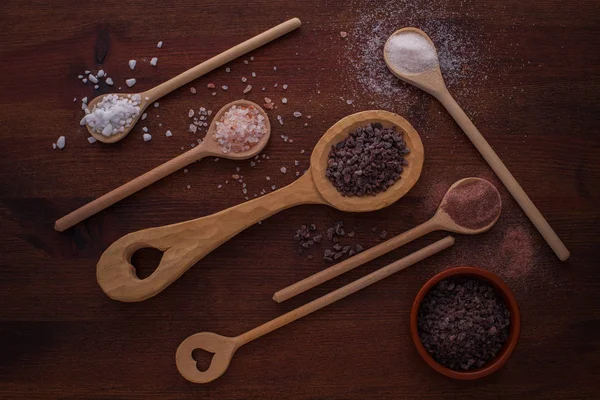 Various salt in wooden spoons — Stock fotografie