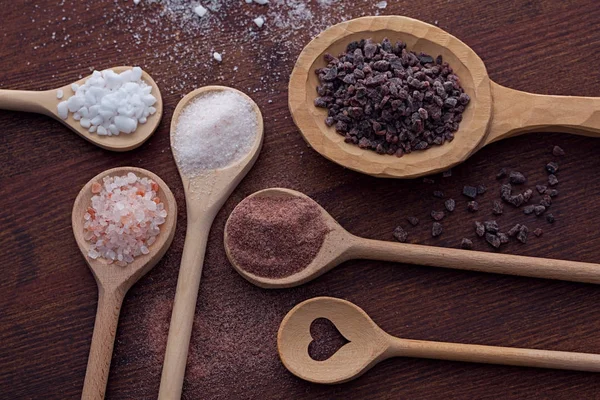 Various salt in wooden spoons — Stock fotografie