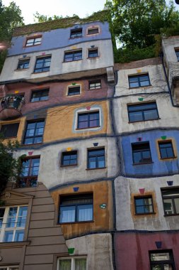 Vienna, Austria - July 7 2017: The work of the famous architect Hundertwasser. Hundertwasser House - colorful and asymmetric, one of the iconic landmarks in Vienna.  clipart