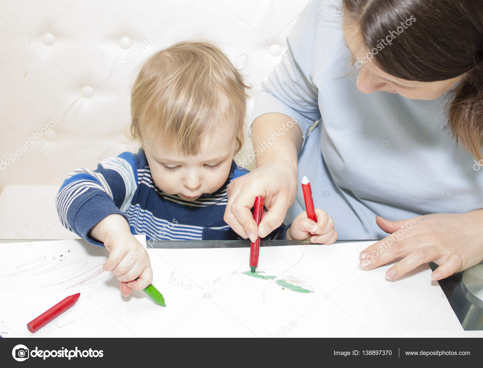 Mother And Son Are Drawing Together With Pencils At Table Stock