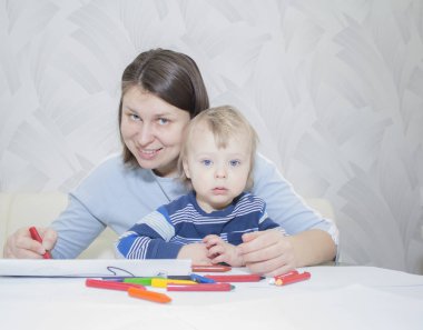 Anne ve oğlu ile birlikte kalem masada çizim