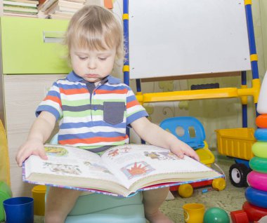 küçük çocuk lazımlık üzerinde oturan