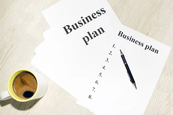 An inscription of the business plan, execution points, there is a notebook and a calculator next to it — Stock Photo, Image