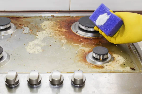 Close up of woman cleaning cooker at home kitchen — Stock Photo, Image