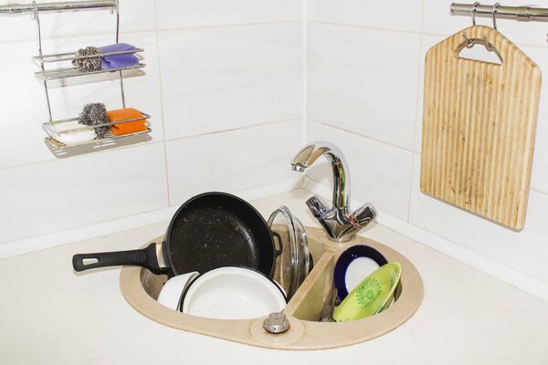 huge heap of dirty dishes waiting for the flatmate