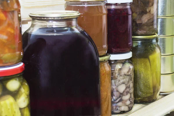 Storage shelves in pantry with homemade canned preserved fruits and vegetables