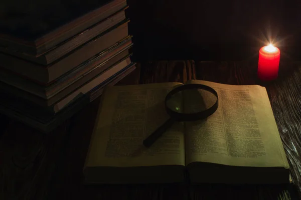 Svíčka a kniha Bible o dřevěné pozadí v noci — Stock fotografie