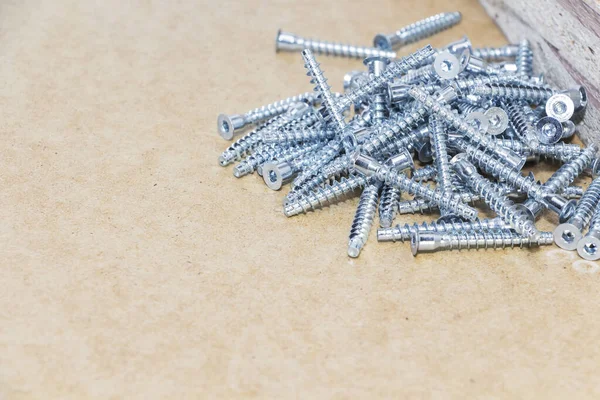 Screw-on for furniture. Metal screw. Vertical. Metal screws. Furniture fittings and fittings. Stainless steel. Realistic.