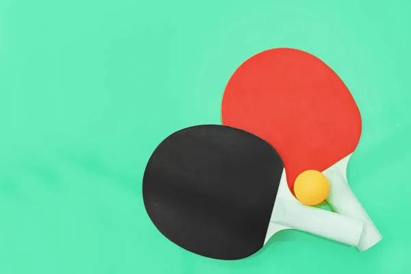 two ping pong table tennis rackets on a bright background.