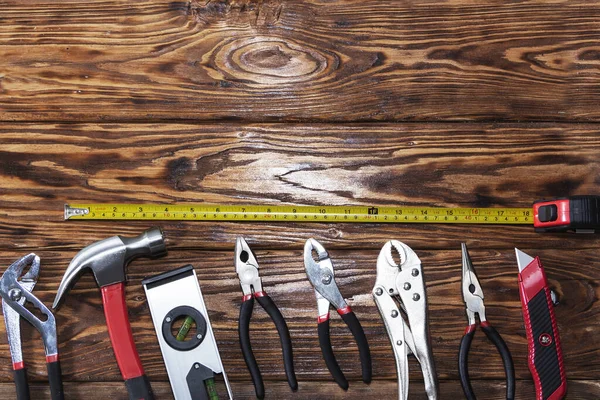 Close up tools on a wooden background. Royalty Free Stock Images